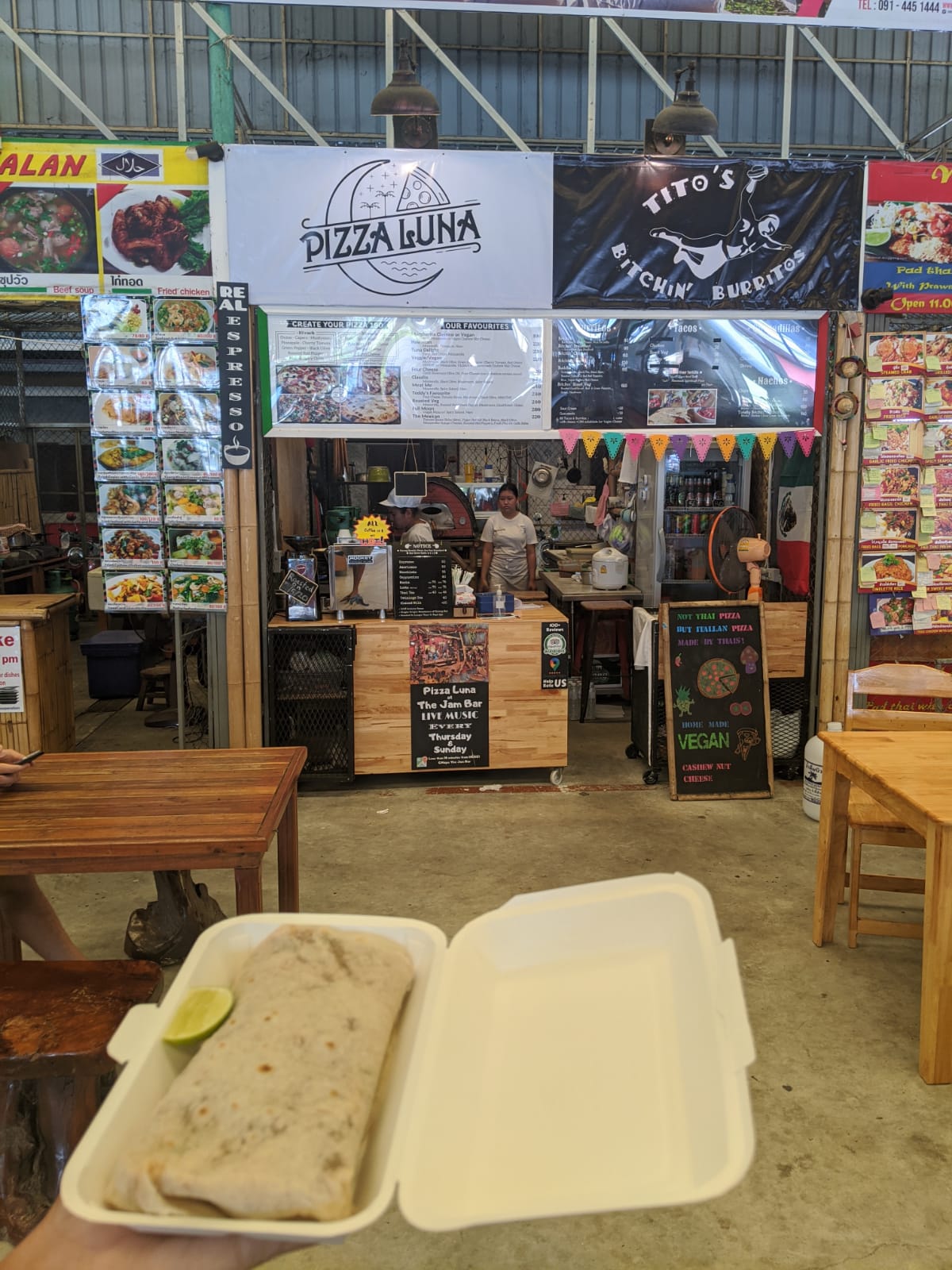 Vegan burrito in a takeaway box in front of the Pizza Luna and Tito's Bitchin' Burritos stall, Koh Phangan