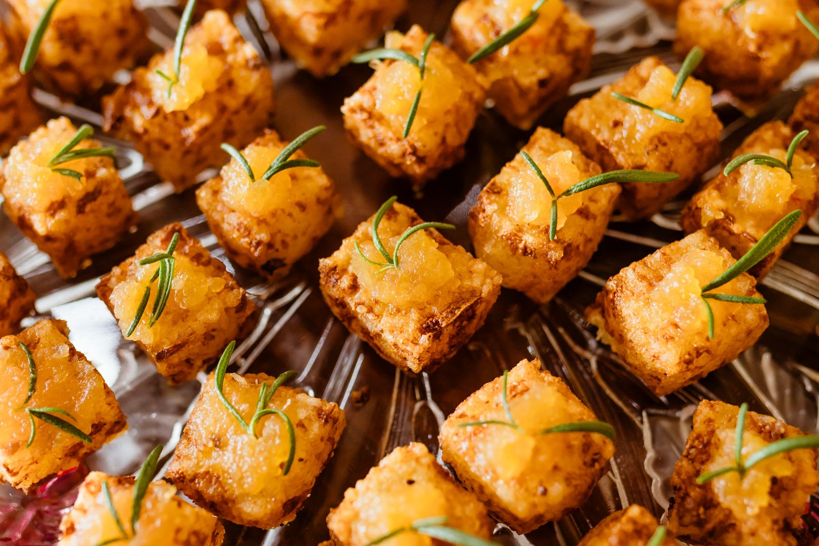 Baked tofu cubes on skewers garnished with fresh herbs